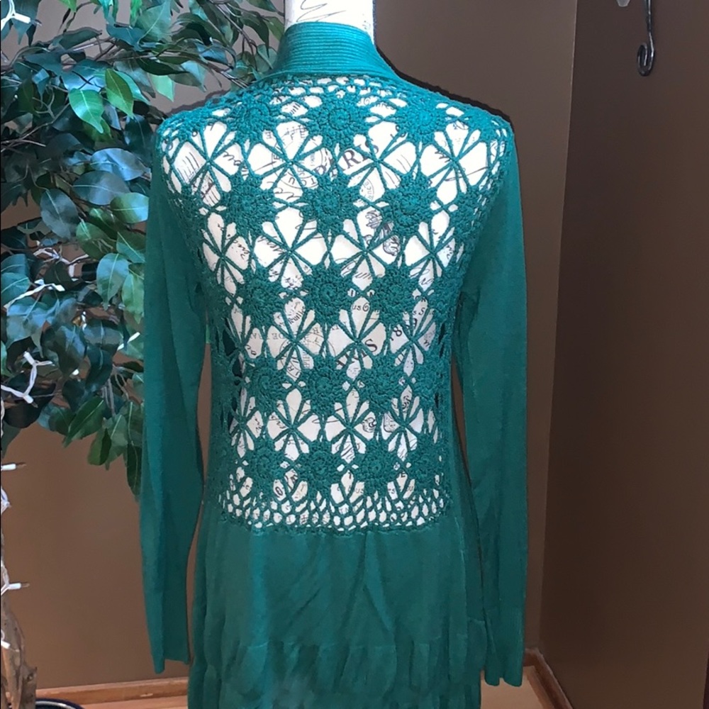 Green sweater with crocheted back